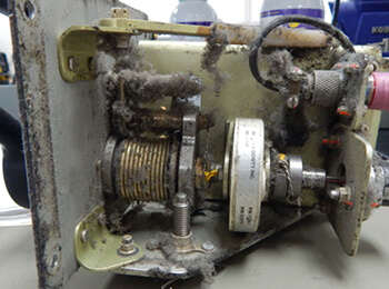 a dusty, dirty, nose wheel steering module of a bombardier CRJ aircraft